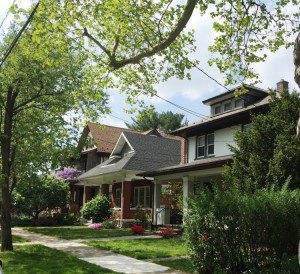 Suburban houses with trees and greenery.