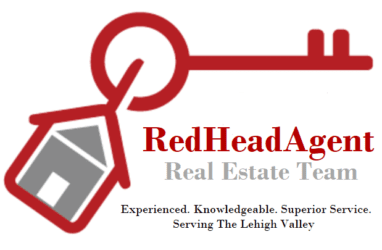 Logo for RedHeadAgent Real Estate Team with a key and house design.
