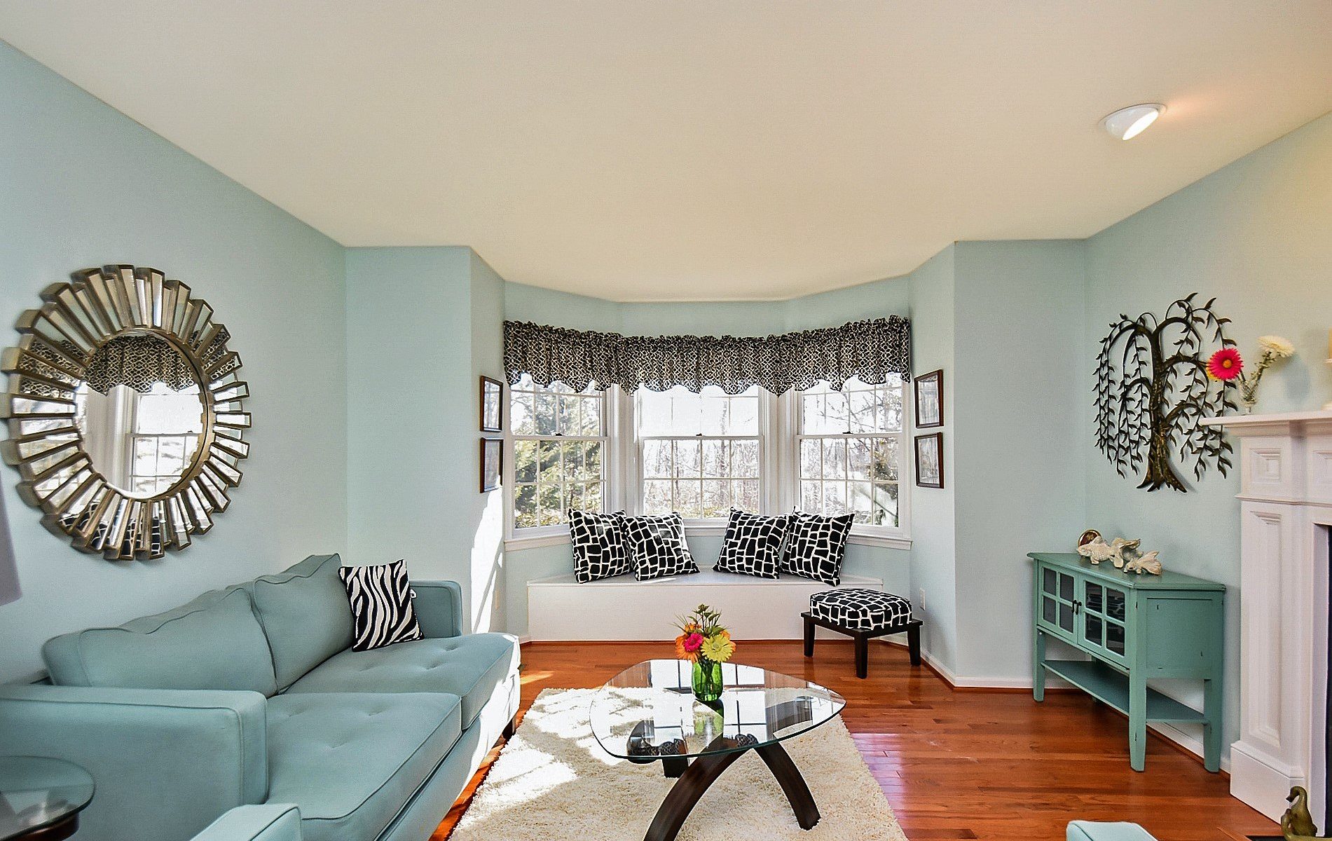 Living room with blue walls and hardwood floors.