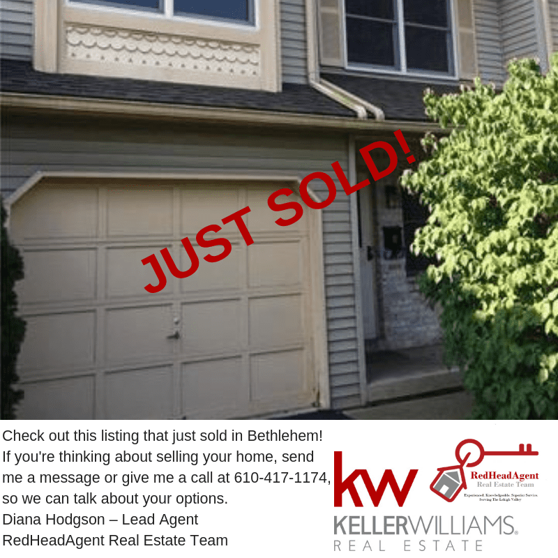 House with "Just Sold" sign in front.