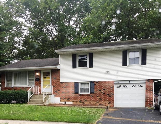 Brick house with garage and front steps.